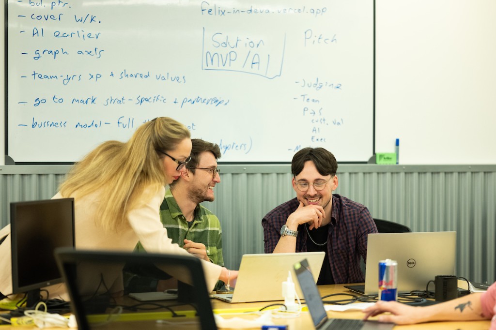Team collaborating at a whiteboard during a workshop